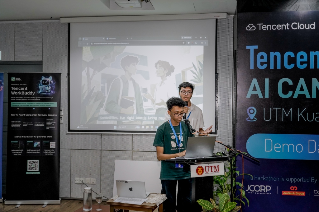 Ahmad Suliman demonstrating THRESHOLD live at the podium with Rahbab Chowdhury beside him during the Tencent Cloud × UTM Hackathon Demo Day in Kuala Lumpur.