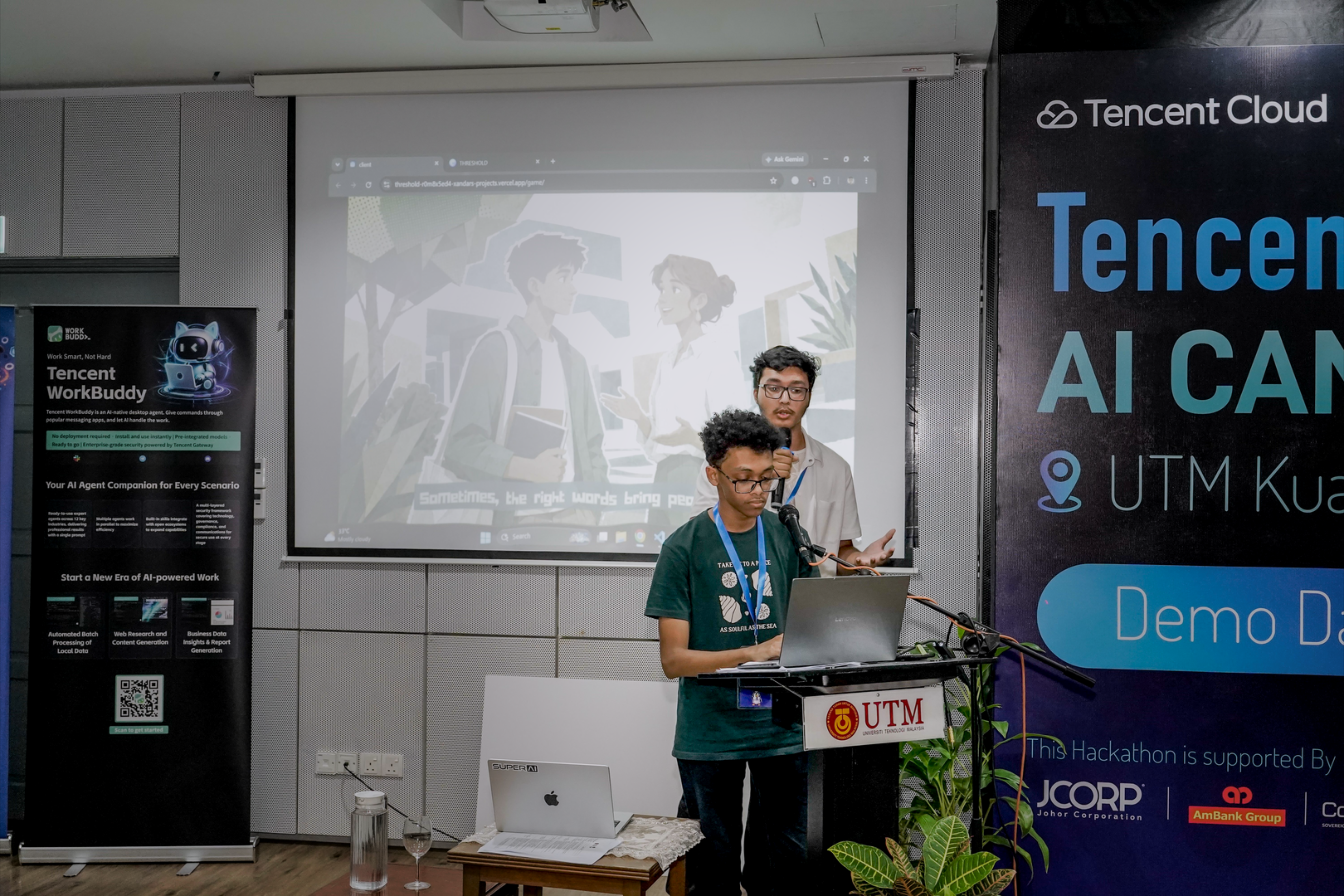 Ahmad Suliman and Rahbab Chowdhury presenting THRESHOLD, with the game's visual world projected behind them.